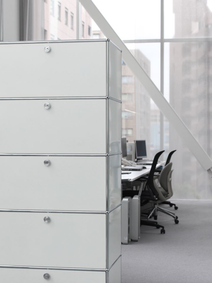 white and chrome USM haller office partition with storage cabinets in a contemporary office