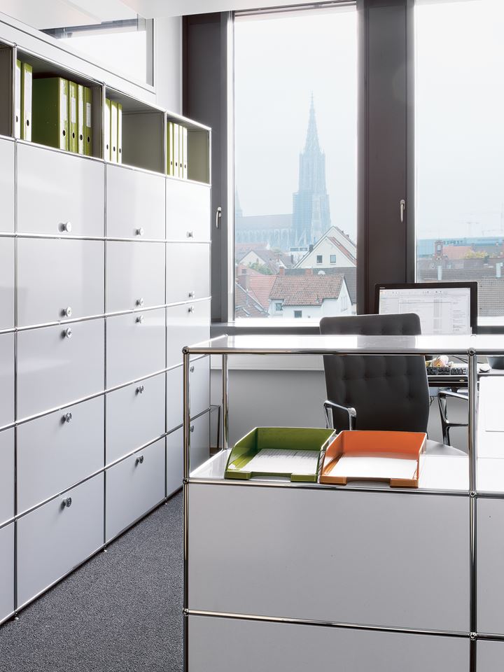 white and chrome USM haller fillling cabinets in a office cubical
