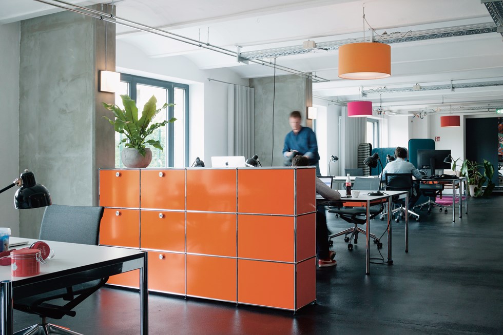 USM Haller persönliche Büroschließfächer orange und Chrom in einem modernen Büro