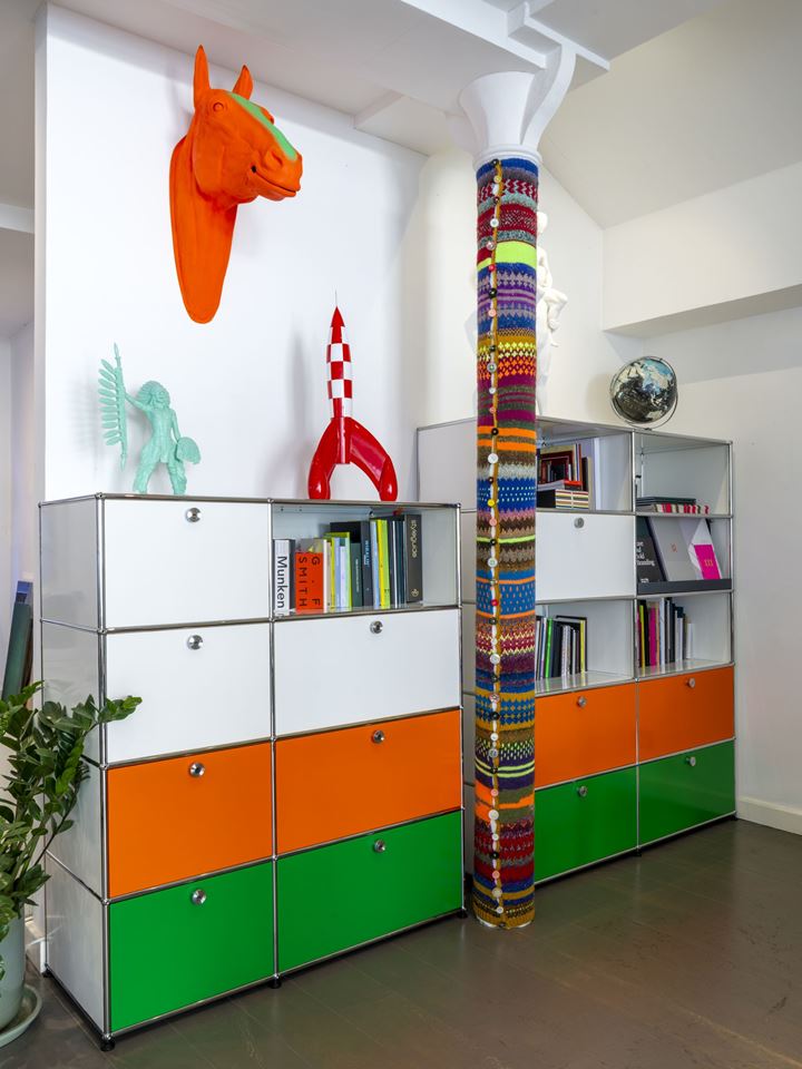open plan creative office with orange USM Haller bookcases