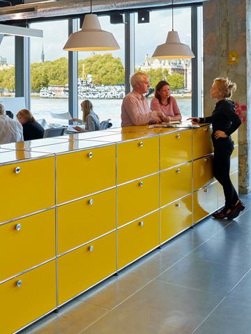 golden yellow USM haller office dividers with storage cabinets in an industrial style office