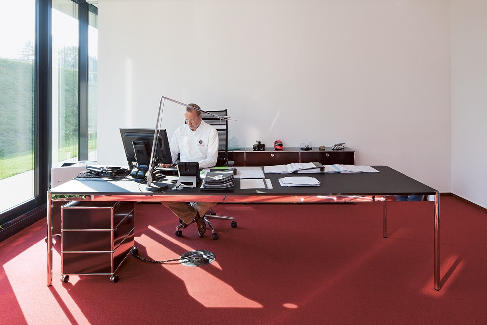 black USM Haller desk and pedestal in red and white executive office