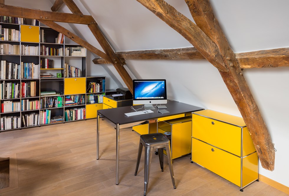 Home office moderno con mobile contenitore USM Haller e scrivanie in giallo