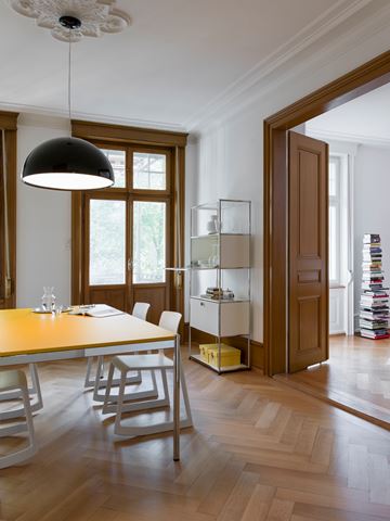 modern dining room with yellow USM Haller table and white display furniture