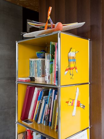usm haller bookshelf with yellow metal finish