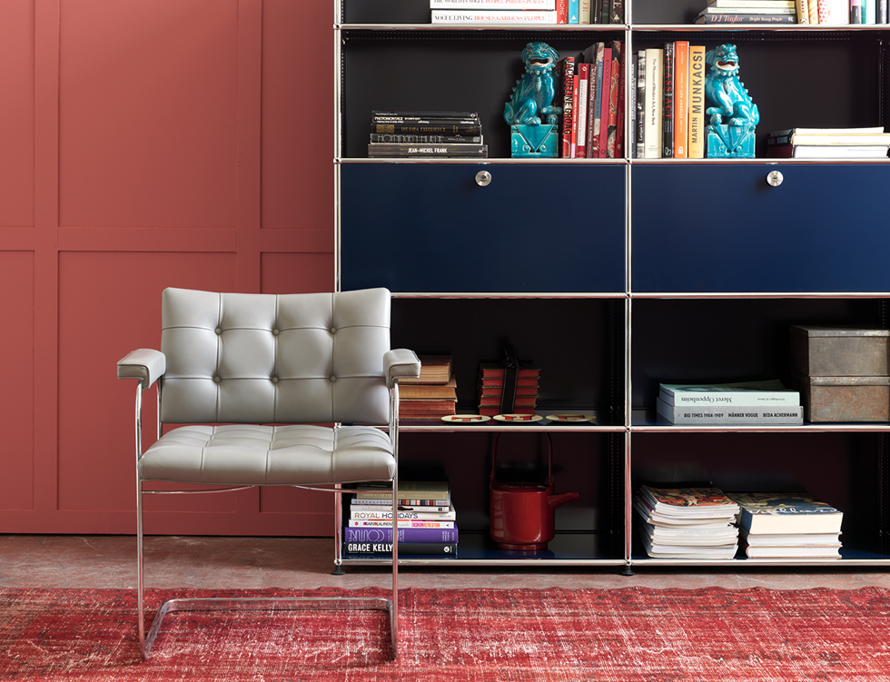Libreria modulare di colore blu acciaio USM in un ambiente contemporaneo nei toni del rosso