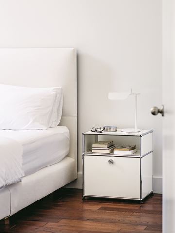 bedside table with large drawer and bookshelf in pure white bedroom