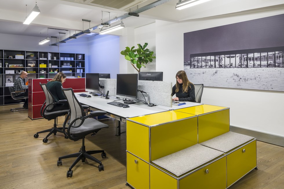 white metal office desks with yellow end of desk storage and shelving