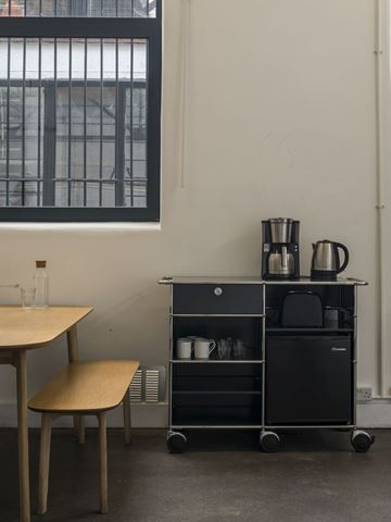 Grey USM Haller catering trolley with fridge in photographic studio